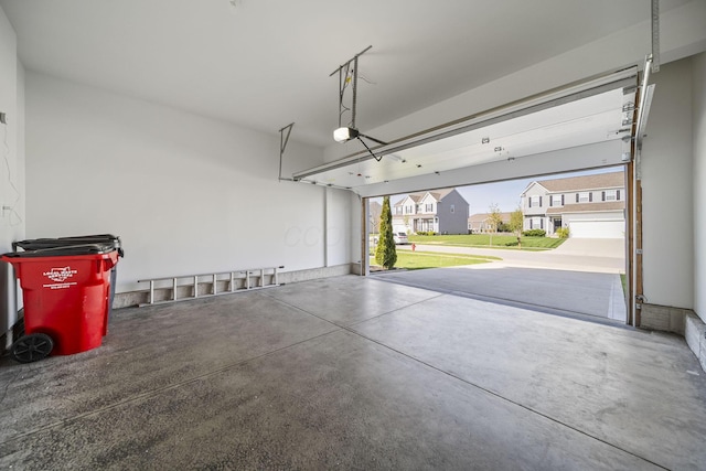 garage with a garage door opener and a residential view