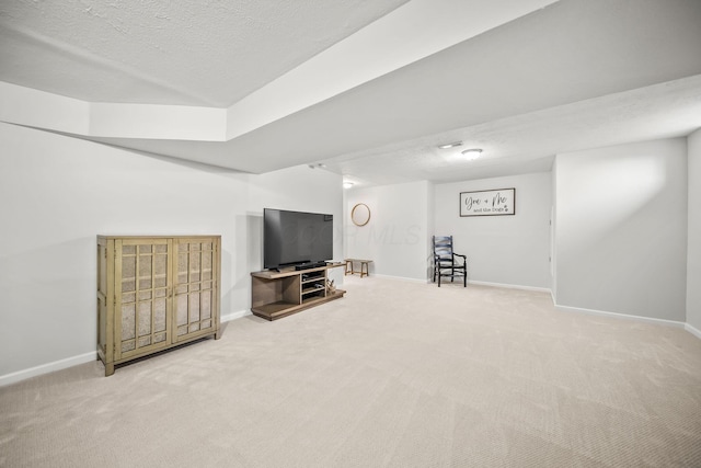 sitting room featuring baseboards, carpet flooring, and a textured ceiling