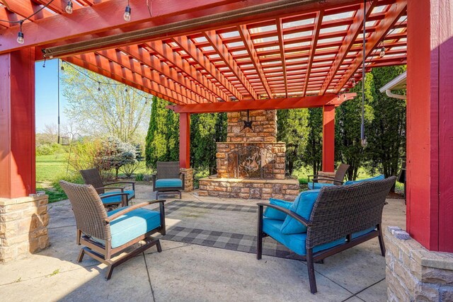 view of patio / terrace featuring an outdoor stone fireplace and a pergola