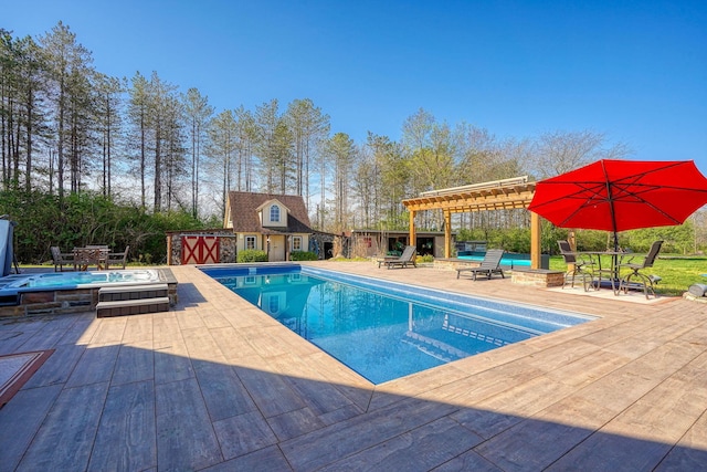 outdoor pool featuring a pergola, an outbuilding, a patio area, and outdoor dining space