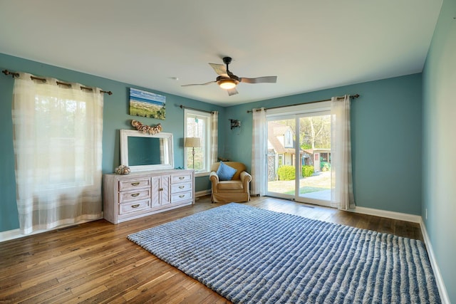 sitting room with wood-type flooring, a ceiling fan, and baseboards