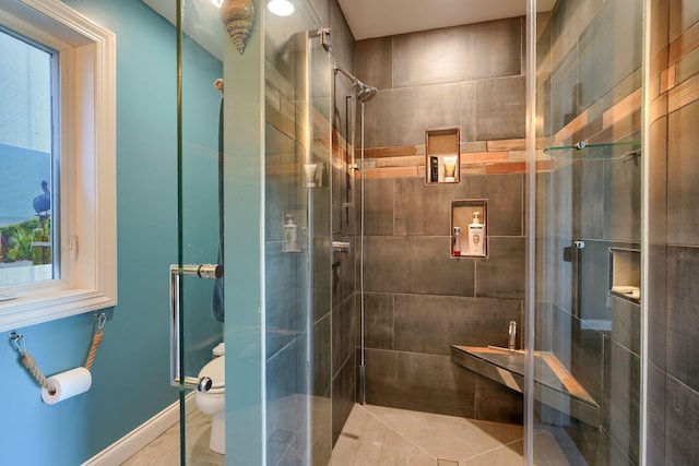 bathroom featuring a shower stall and toilet