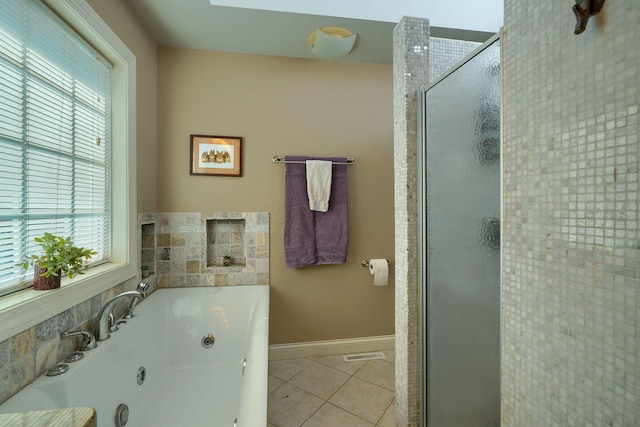 bathroom featuring a healthy amount of sunlight, tile patterned floors, a jetted tub, and a shower stall