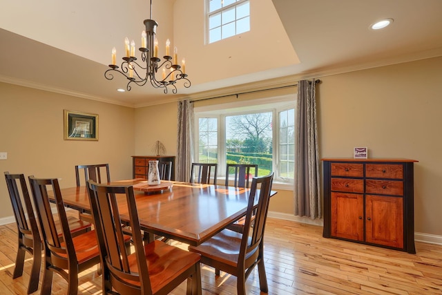dining area featuring a healthy amount of sunlight, crown molding, and an inviting chandelier