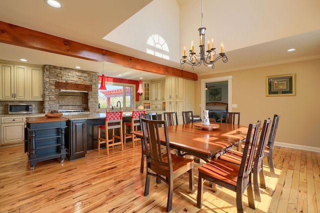 dining space with recessed lighting, light wood-type flooring, and a notable chandelier