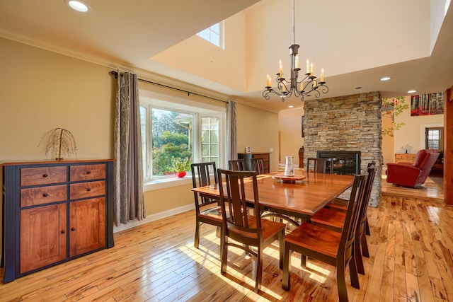 dining room featuring ornamental molding, plenty of natural light, and light wood-style flooring