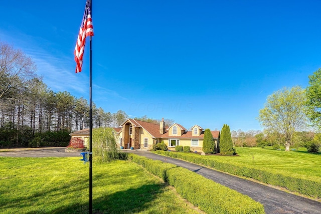 view of front facade featuring a front lawn and stone siding