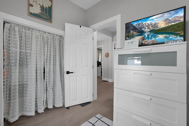 interior space with baseboards and wood finished floors
