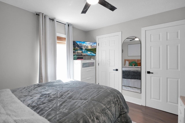 bedroom featuring a ceiling fan and dark wood-style flooring