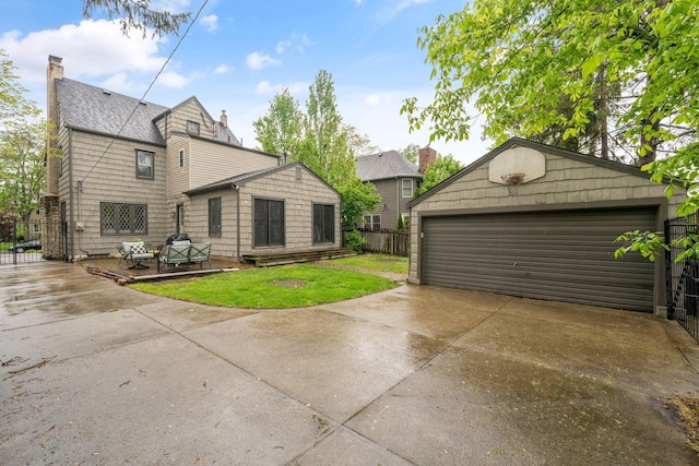152 S Stanwood Rd, Columbus, OH 43209 - back of house featuring an outdoor structure, a garage, fence, and a chimney