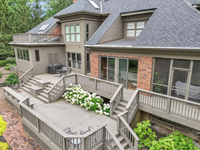 wooden deck with stairs and area for grilling