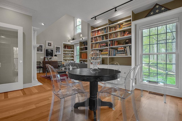 dining space with visible vents, track lighting, light wood finished floors, and plenty of natural light