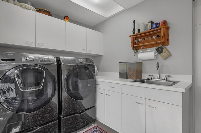 laundry room with a sink, cabinet space, and independent washer and dryer