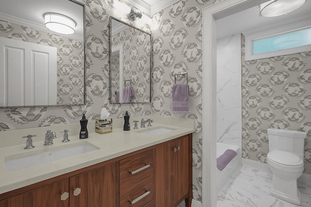 bathroom with a sink, toilet, and wallpapered walls
