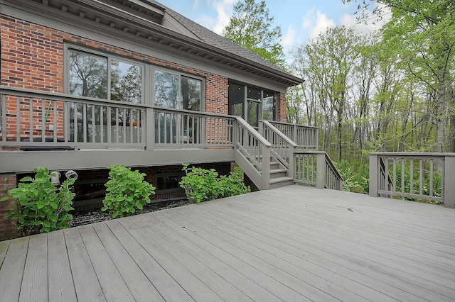 deck featuring stairs and a sunroom