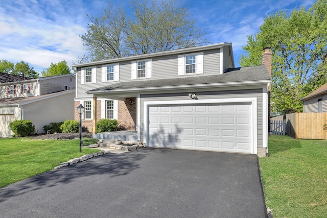 7847 Maplecreek Ct, Powell, OH 43065 - traditional-style house with a front lawn, fence, driveway, and a chimney