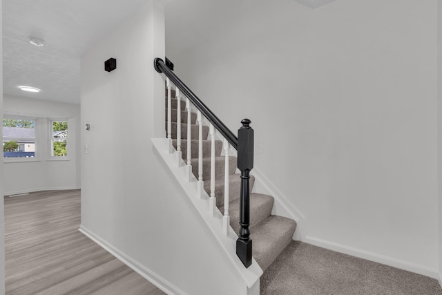 7847 Maplecreek Ct, Powell, OH 43065 - stairs featuring a textured ceiling, baseboards, and wood finished floors