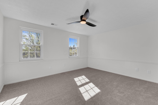 7847 Maplecreek Ct, Powell, OH 43065 - empty room with wainscoting, carpet floors, a ceiling fan, baseboards, and visible vents