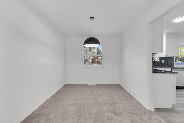 7847 Maplecreek Ct, Powell, OH 43065 - unfurnished dining area featuring baseboards, light carpet, and visible vents