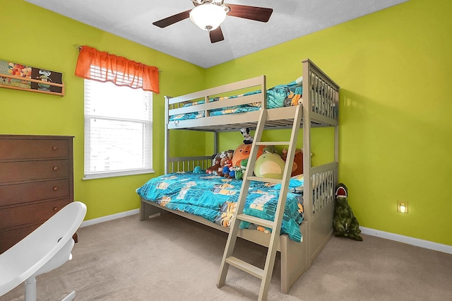 carpeted bedroom with a ceiling fan and baseboards