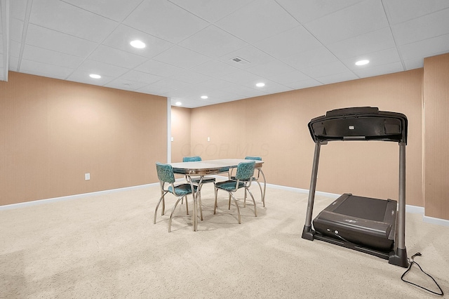 exercise area featuring baseboards, carpet, and a drop ceiling