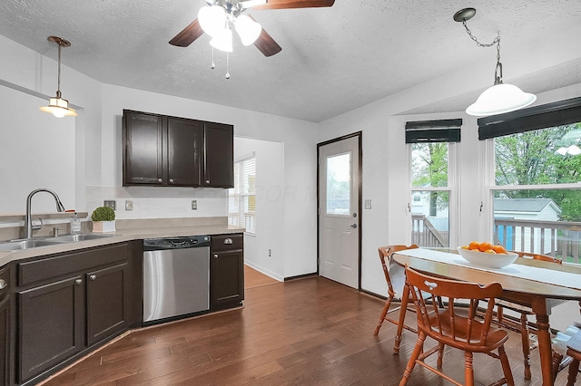 kitchen featuring a textured ceiling, ceiling fan, a sink, and dishwasher