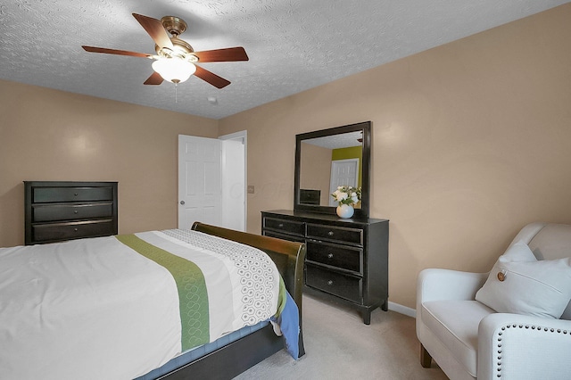 bedroom with a textured ceiling, baseboards, light carpet, and ceiling fan