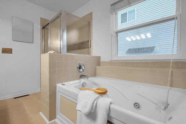 full bath with tile patterned flooring, a jetted tub, baseboards, a shower stall, and visible vents