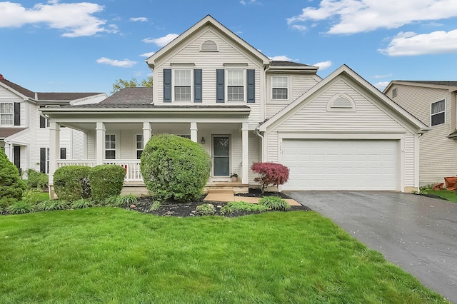 view of front of house featuring covered porch, a front yard, and aphalt driveway