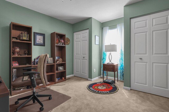 carpeted office space with baseboards