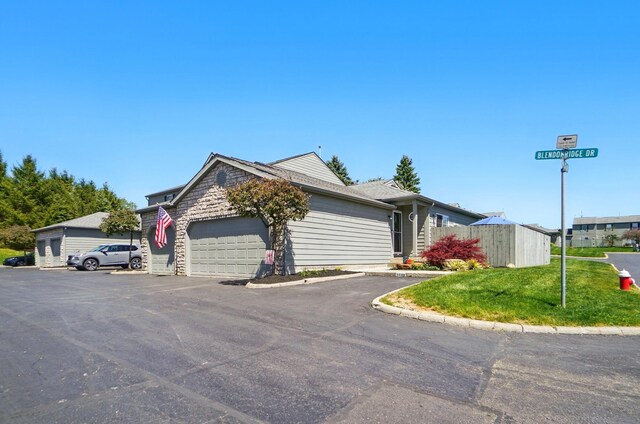 5688 Blendonridge Dr Unit 93E, Columbus, OH 43230 - ranch-style home with a garage, driveway, and a front lawn