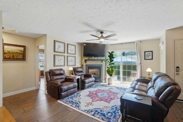 5688 Blendonridge Dr Unit 93E, Columbus, OH 43230 - living room with a fireplace, a textured ceiling, hardwood / wood-style floors, a ceiling fan, and baseboards