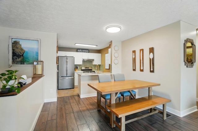 5688 Blendonridge Dr Unit 93E, Columbus, OH 43230 - dining space with dark wood-style flooring, baseboards, and a textured ceiling