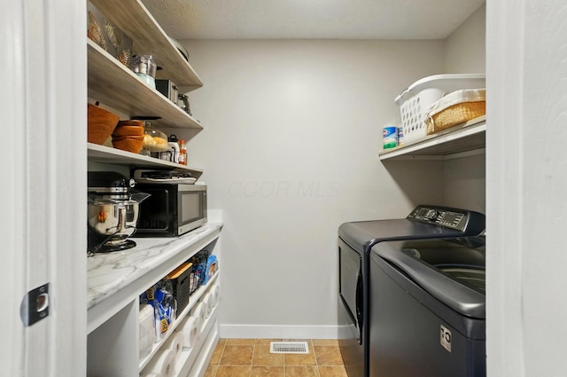 5688 Blendonridge Dr Unit 93E, Columbus, OH 43230 - laundry room with baseboards, laundry area, independent washer and dryer, and visible vents