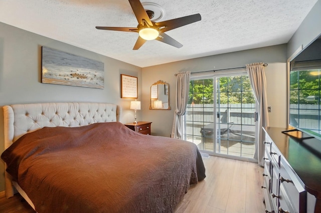 5688 Blendonridge Dr Unit 93E, Columbus, OH 43230 - bedroom featuring light wood-style floors, access to outside, a ceiling fan, and a textured ceiling