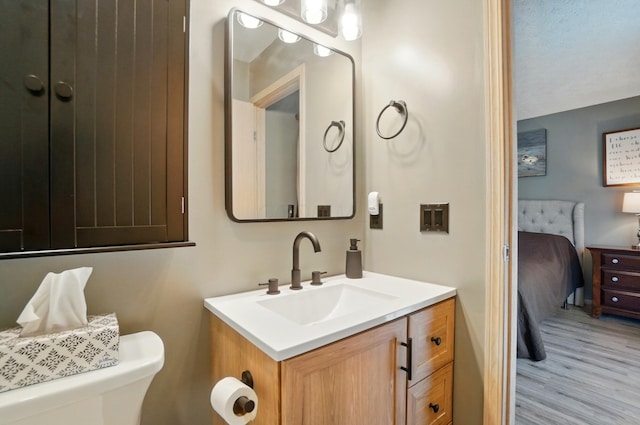 5688 Blendonridge Dr Unit 93E, Columbus, OH 43230 - bathroom with vanity, toilet, ensuite bath, and wood finished floors