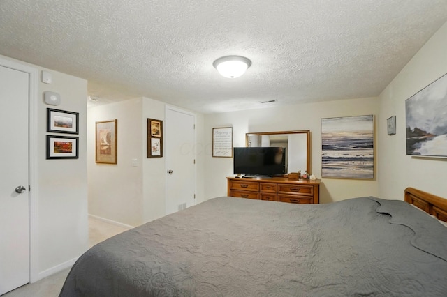 5688 Blendonridge Dr Unit 93E, Columbus, OH 43230 - bedroom featuring baseboards, a textured ceiling, and visible vents