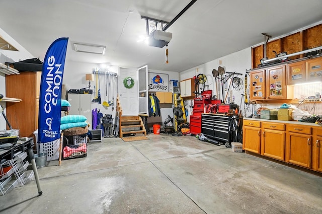 5688 Blendonridge Dr Unit 93E, Columbus, OH 43230 - garage featuring a garage door opener and a workshop area