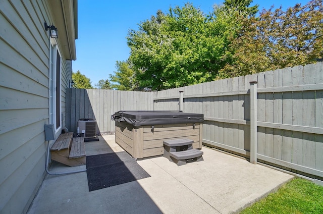 5688 Blendonridge Dr Unit 93E, Columbus, OH 43230 - view of patio with a fenced backyard, a hot tub, and central air condition unit