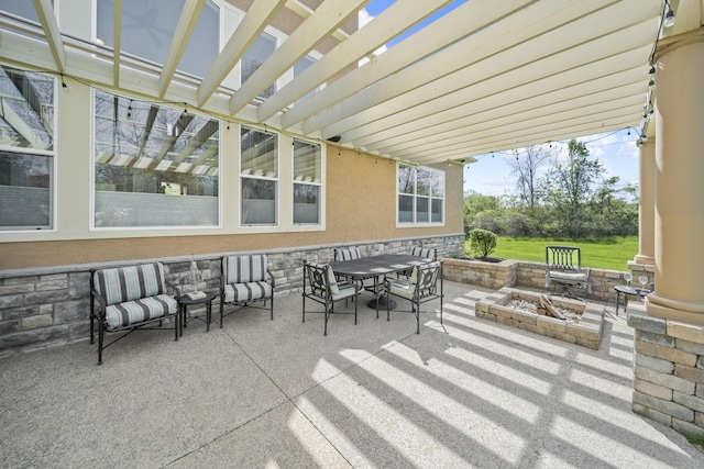 view of patio featuring a pergola, a fire pit, and outdoor dining space