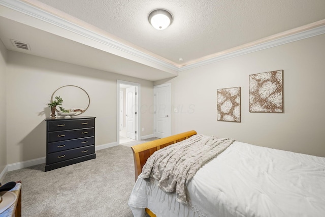 bedroom with visible vents, ornamental molding, baseboards, a textured ceiling, and carpet flooring