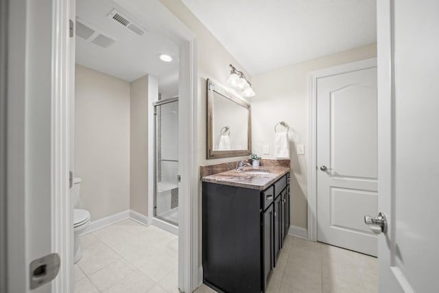bathroom with visible vents, vanity, toilet, tile patterned floors, and a stall shower
