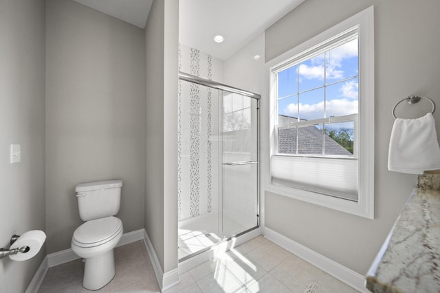 full bath featuring baseboards, tile patterned flooring, a stall shower, and toilet