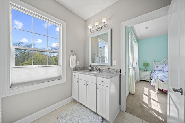 ensuite bathroom with connected bathroom, tile patterned flooring, vanity, baseboards, and visible vents
