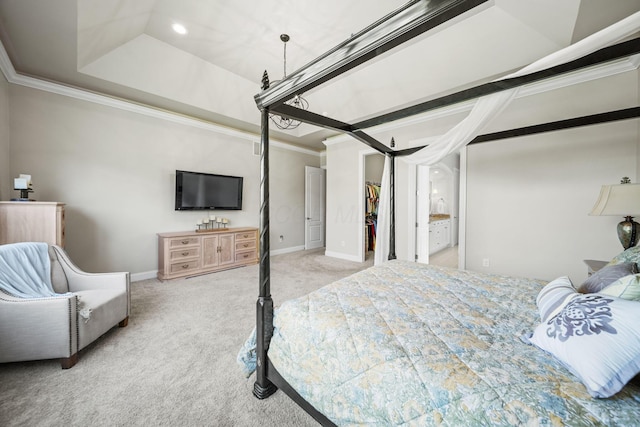 bedroom featuring crown molding, baseboards, a walk in closet, and light colored carpet