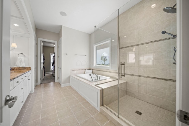 full bathroom with vanity, a stall shower, a bath, and tile patterned floors