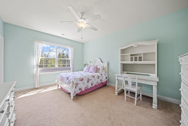bedroom with light colored carpet, baseboards, and ceiling fan