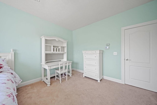 bedroom featuring baseboards and light colored carpet