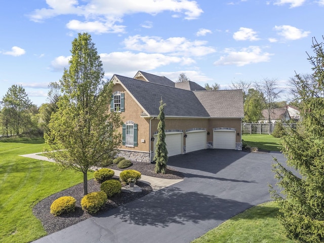 view of front of property with a shingled roof, a front lawn, aphalt driveway, stone siding, and stucco siding