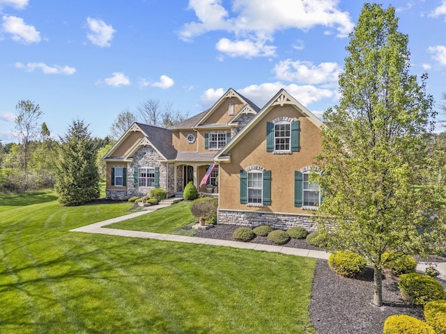 craftsman-style house featuring a front lawn, stucco siding, and stone siding